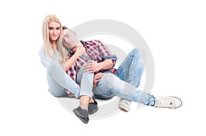 Playful and loving couple sitting on the floor