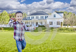 Playful Mixed Race Boy Throwing a Football in His Front Yard