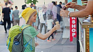 A playful moment unfolds as a boy anticipates the taste of creamy Turkish ice cream, only to be met with the