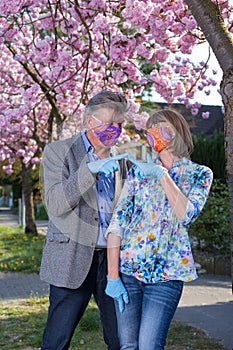 Playful senior couple in love pointing fingers.