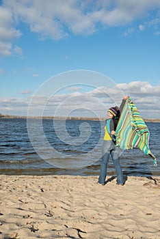 Playful smiling woman having fun, playing with a veil, coverlet