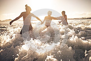 Playful summer people enjoy the ocean wave together in friendship playing and having fun together - concept of tourism and travel