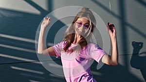 Playful summer pink street dancer person smiling dancing outdoor. Medium shot on RED camera