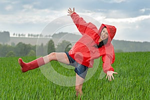 Playful teenage girl dancing in the rain