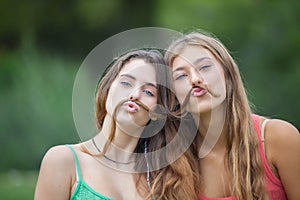 Playful teens with hair moustache