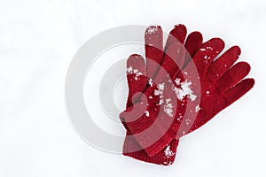 Playful Winter. Gloves lying on snow background