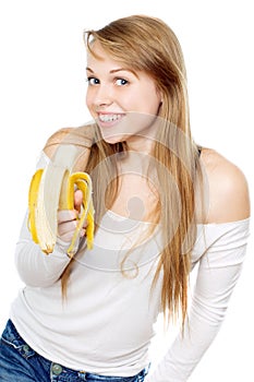 Playful woman holding banana