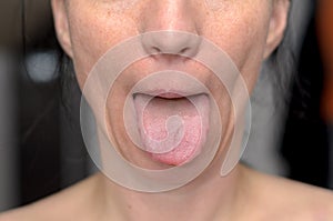 Playful woman sticking out her tongue