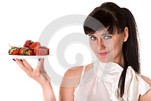 Playful woman with strawberries on plate photo