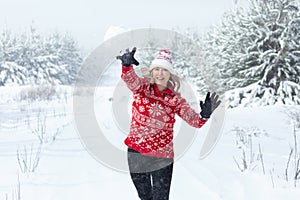 Playful woman throwing a snowball