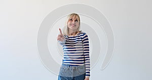 Playful Woman Wagging Her Finger on White Background