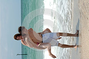 Playful young beach couple