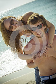 Playful young beach couple