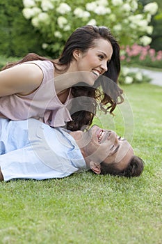 Playful young couple having leisure time in park