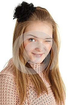 Playful young girl winks on white background