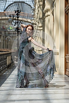 Playful young model in fashionable gauzy clothing