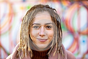 Playful young woman with braided hair outdoors