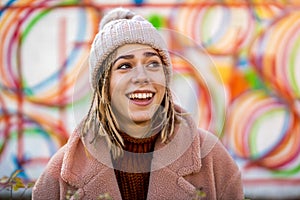 Playful young woman with braided hair outdoors