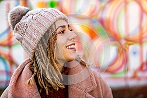 Playful young woman with braided hair outdoors