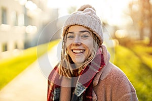 Playful young woman with braided hair outdoors