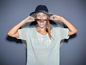 Playful young woman making a pretence moustache