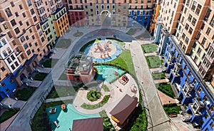 Playground for children and house building exterior mixed-use urban multi-family residential complex district. top view