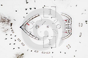 Playground covered of fresh snow to symbolize end of season  top down view.