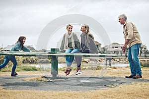 Playground, family and happy people in a nature play park with a mom, child and grandparents. Mother with children