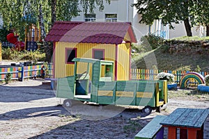 Playground with a green wooden car and a small house