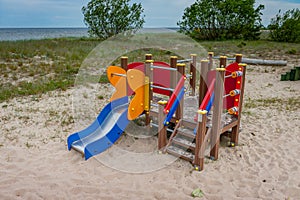 Playground for kids on the sand near the sea.