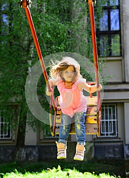 Playground in park. childhood daydream .teen freedom. Happy laughing child girl on swing. Small kid playing in summer