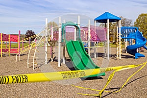 Playground and slides closed with yellow tape, Coronavirus