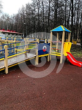 Playground, slides, swings, a ladder in city park