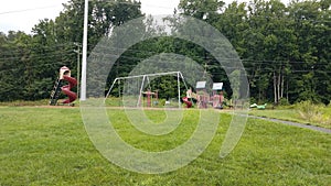 Playground with slides and swingset and grass