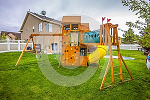 Playground structure with slide swings playhouse tower and climbing wall