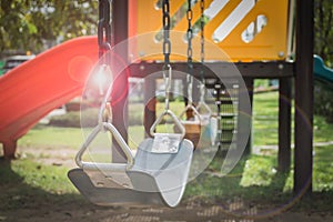 Playground swing set with lens flare (selective focus)
