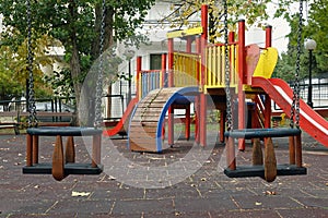 Playground swings and play structure equipment with slides