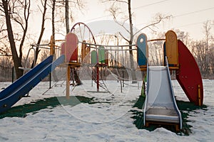 A playground in winter during sunset