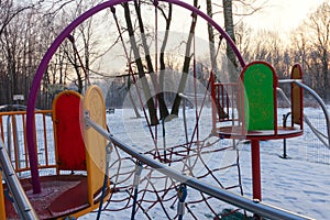 A playground in winter during sunset