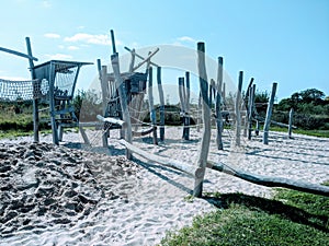 huge wooden playground with sand as a safetyground