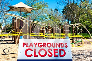Playgrounds closed sign with blurred outdoor children playground
