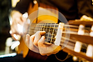 Playing an acoustic guitar