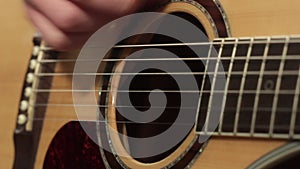 Playing on the acoustic guitar. Musical instrument with guitarist hands