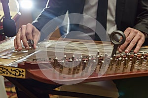 Playing Arabian Qanon Musical Instrument photo