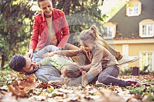 Playing at backyard at autumn season is fun. Happy family.