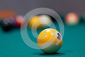 Playing biliard in a pool.