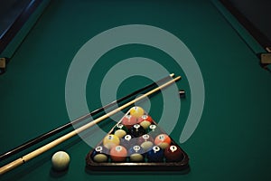 Playing billiard. Billiards balls and cue on green billiards table. Billiard sport concept.