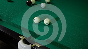 Playing billiard game. White pool ball close-up on green billiards table in pocket. Russian game, Russian pyramid