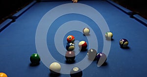 Playing billiards cue hit on ball on table