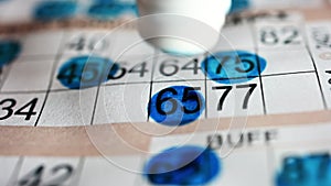 Playing bingo, marking numbers with blue marker